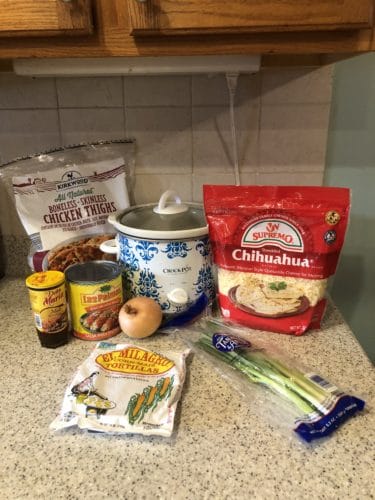 ingredients to make slow cooker chicken enchiladas on a kitchen counter