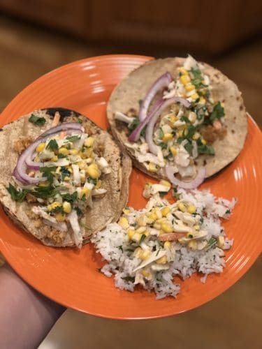 fish tacos and rice on an orange plate