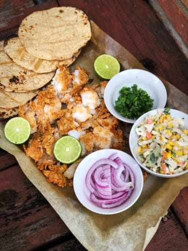 ingredients for baked fish tacos on a sheet pan