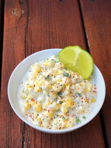 elote dip recipe in a white bowl outside
