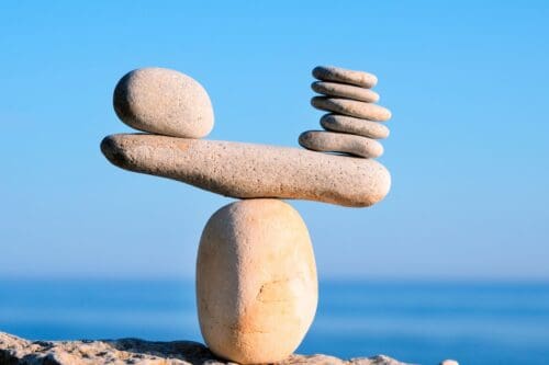 unbalanced scale made from rocks representing marriage challenges