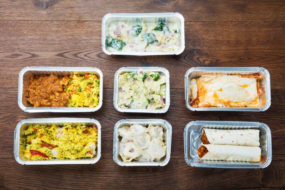 seven containers of meals that were prepared by a mom working as a meal prepper
