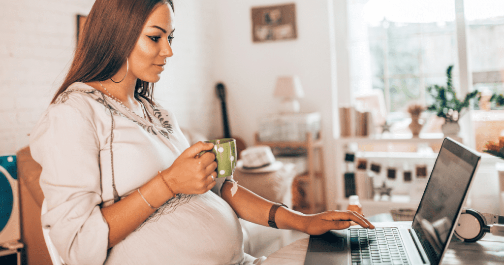 a pregnant medium-complected woman working on her computer to do 
 the best jobs for stay at home moms with no experience